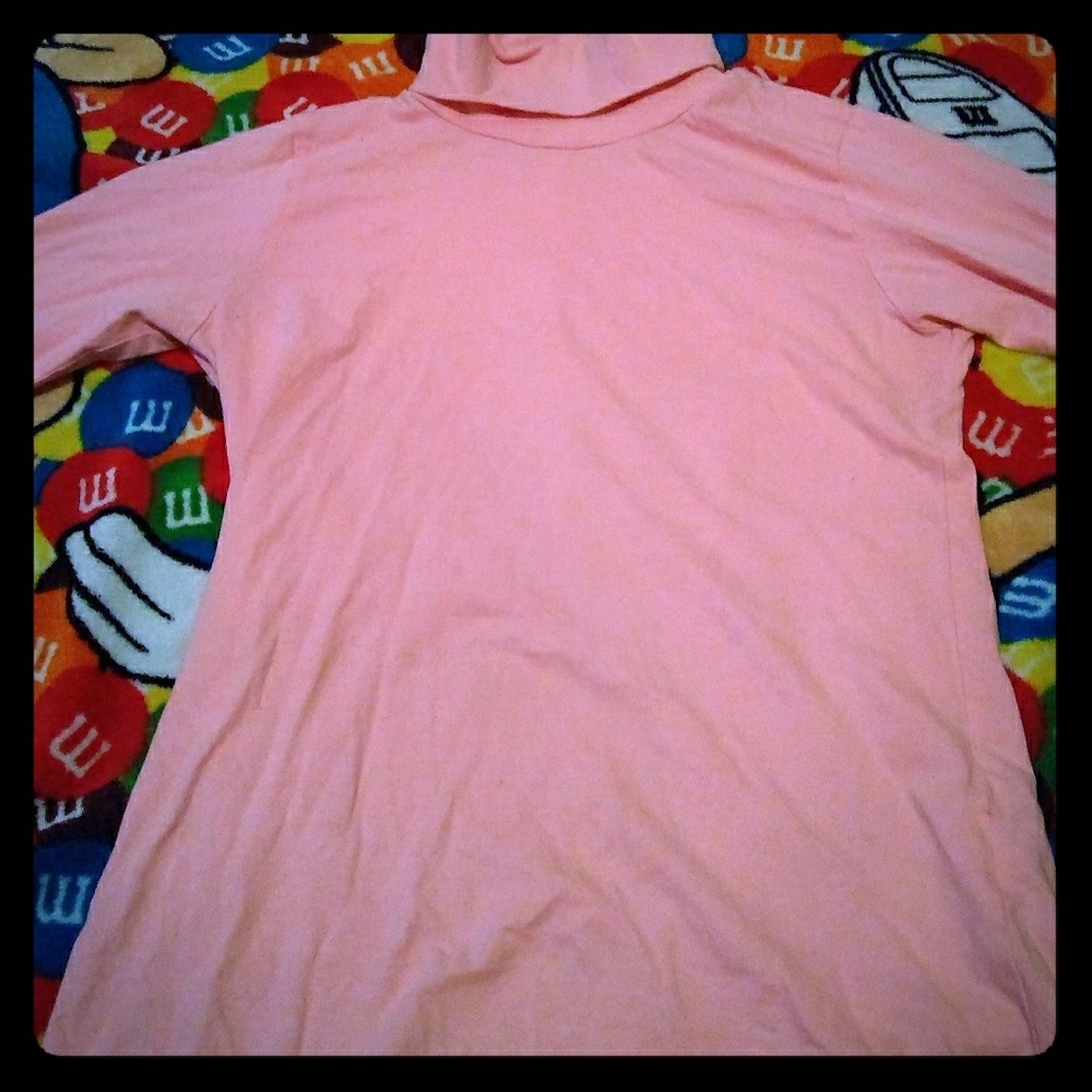 A light/baby pink long sleeve turtle neck shirt